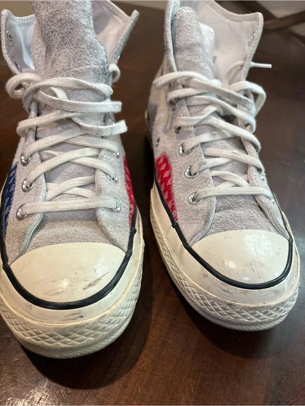 Converse Chuck Taylor’s White High Top Sneakers with Red and Blue Accents